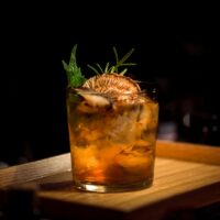 clear glass tumbler on brown wooden tray