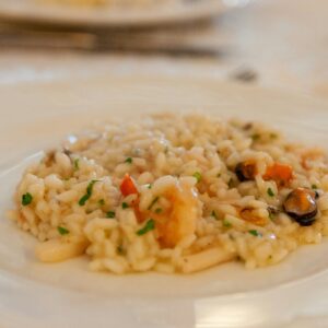 white pasta with green peas on white ceramic plate